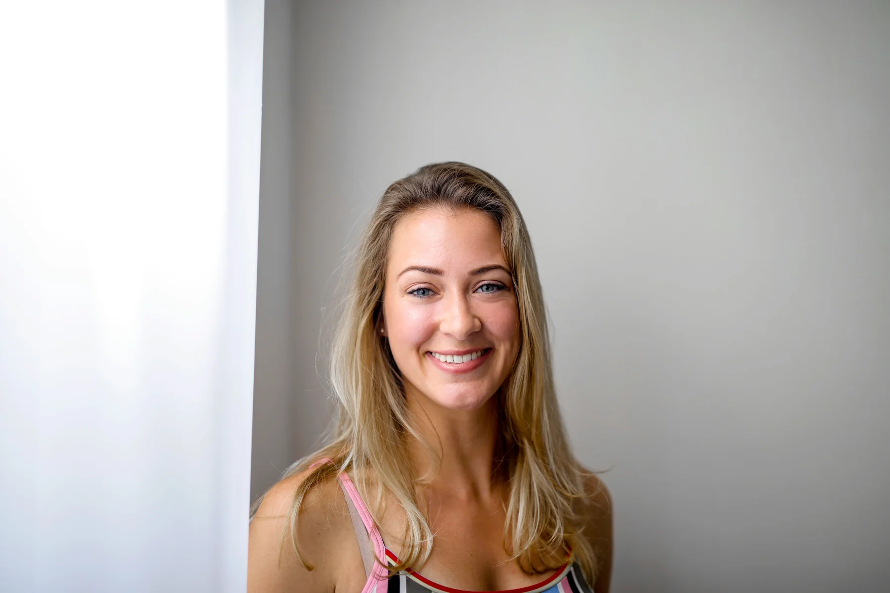 A natural smile in bright window light