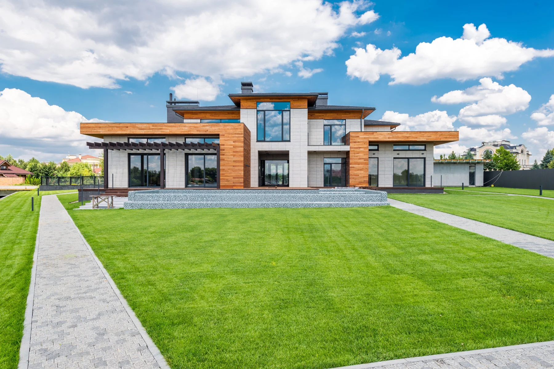 Modern timber and stone home opening onto a garden