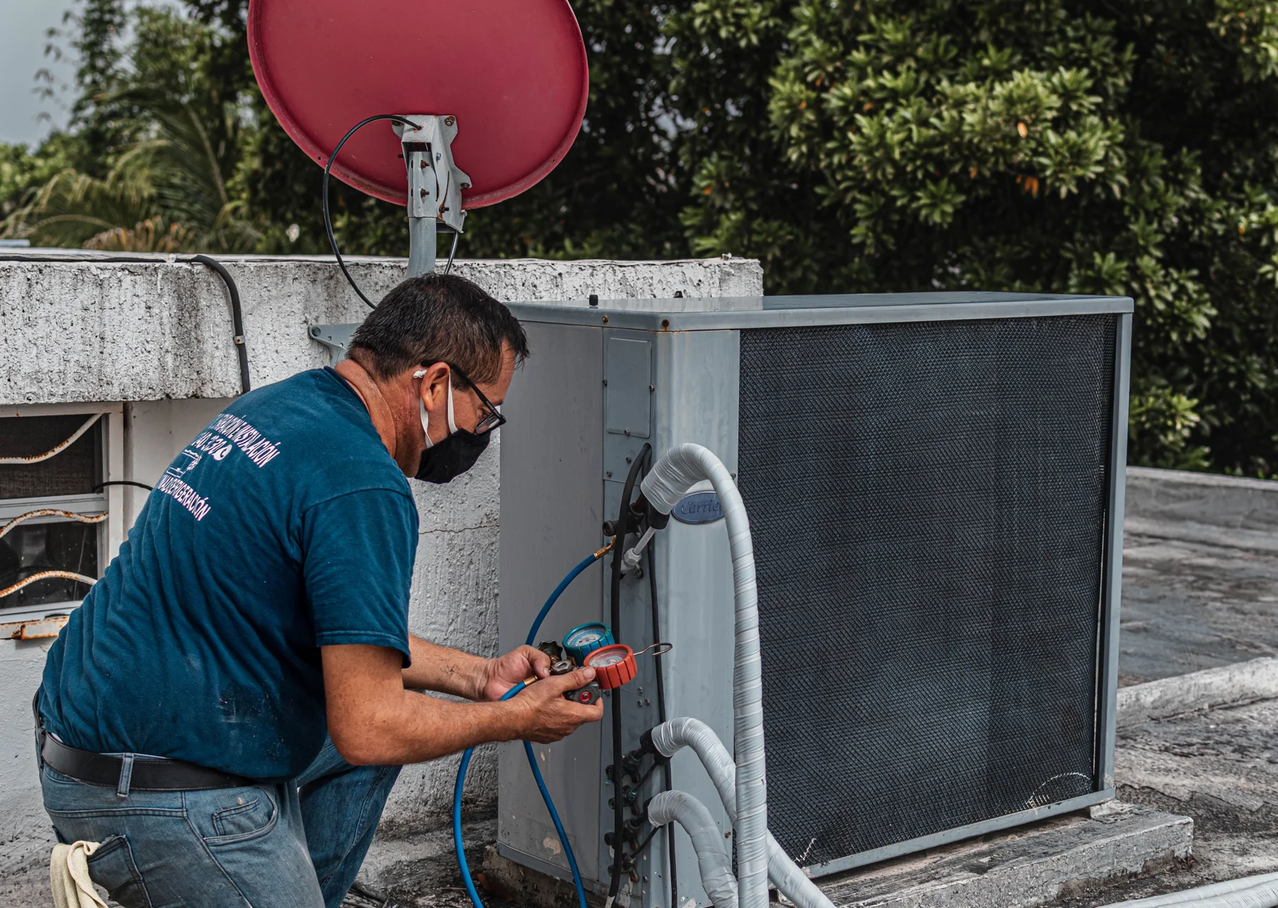 HVAC technician inspecting an outdoor air-conditioning unit
