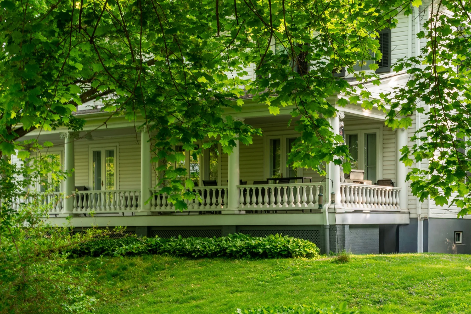 A welcoming home shaded by green trees
